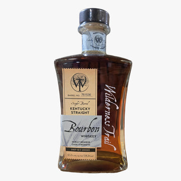 A bottle of Waterman's Trail Kentucky Straight Bourbon Whiskey standing on a cardboard box with a corrugated cardboard wall behind it.