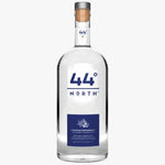 A bottle of 44° North Mountain Meadow Spirit vodka on a solid white background. The bottle is clear glass with a white and blue label, a silver metal cap, and a cork stopper.