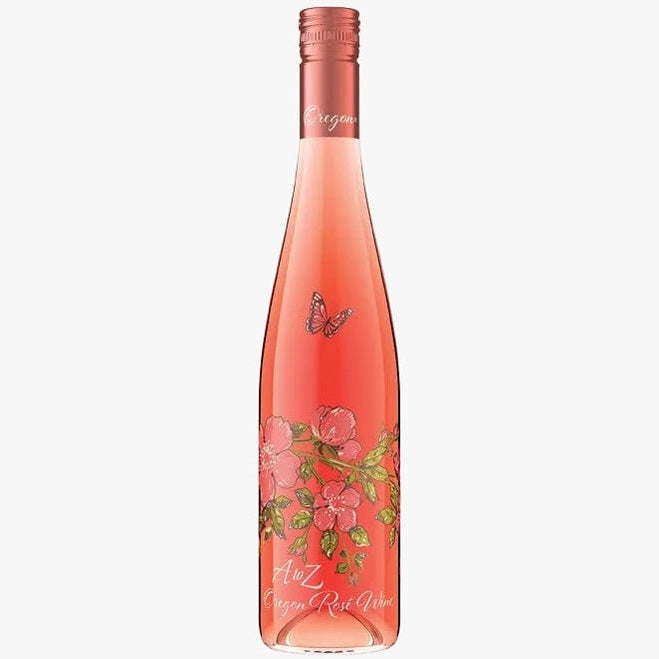A bottle of Alz Oregon Rose Wine with a pinkish-rose liquid, decorated with a butterfly and pink flowers with green leaves on the label, set against a plain white background.