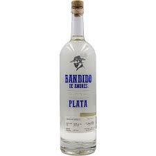 A clear glass bottle of Bandido El Marino Plata tequila with a white label featuring blue text and a gold cork, set against a plain white background.