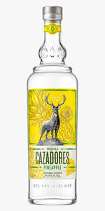Cazadores Pineapple tequila bottle with a deer illustration on a yellow background