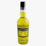 A bottle of Chartreuse liqueur with a black cap and a yellow-green liquid inside a clear glass bottle, shown against a plain white background.