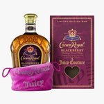 Crown Royal Blackberry flavored whisky bottle displayed next to its purple limited edition packaging box and a pink rhinestone-covered drawstring pouch.