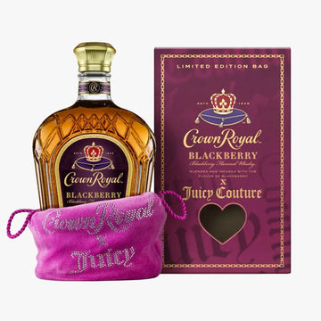 Crown Royal Blackberry flavored whisky bottle displayed next to its purple limited edition packaging box and a pink rhinestone-covered drawstring pouch.