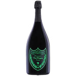 A large black bottle of Dom Pérignon Vintage Champagne with a glowing green shield logo on the front, set against a plain white background.