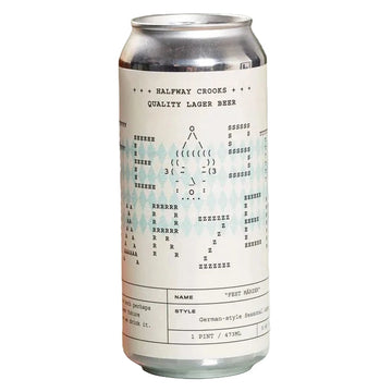 A frothy amber lager beer in a clear glass mug with a blue geometric logo, standing beside a silver can labeled Halfway Crookes Quality Lager Beer against an olive green background.