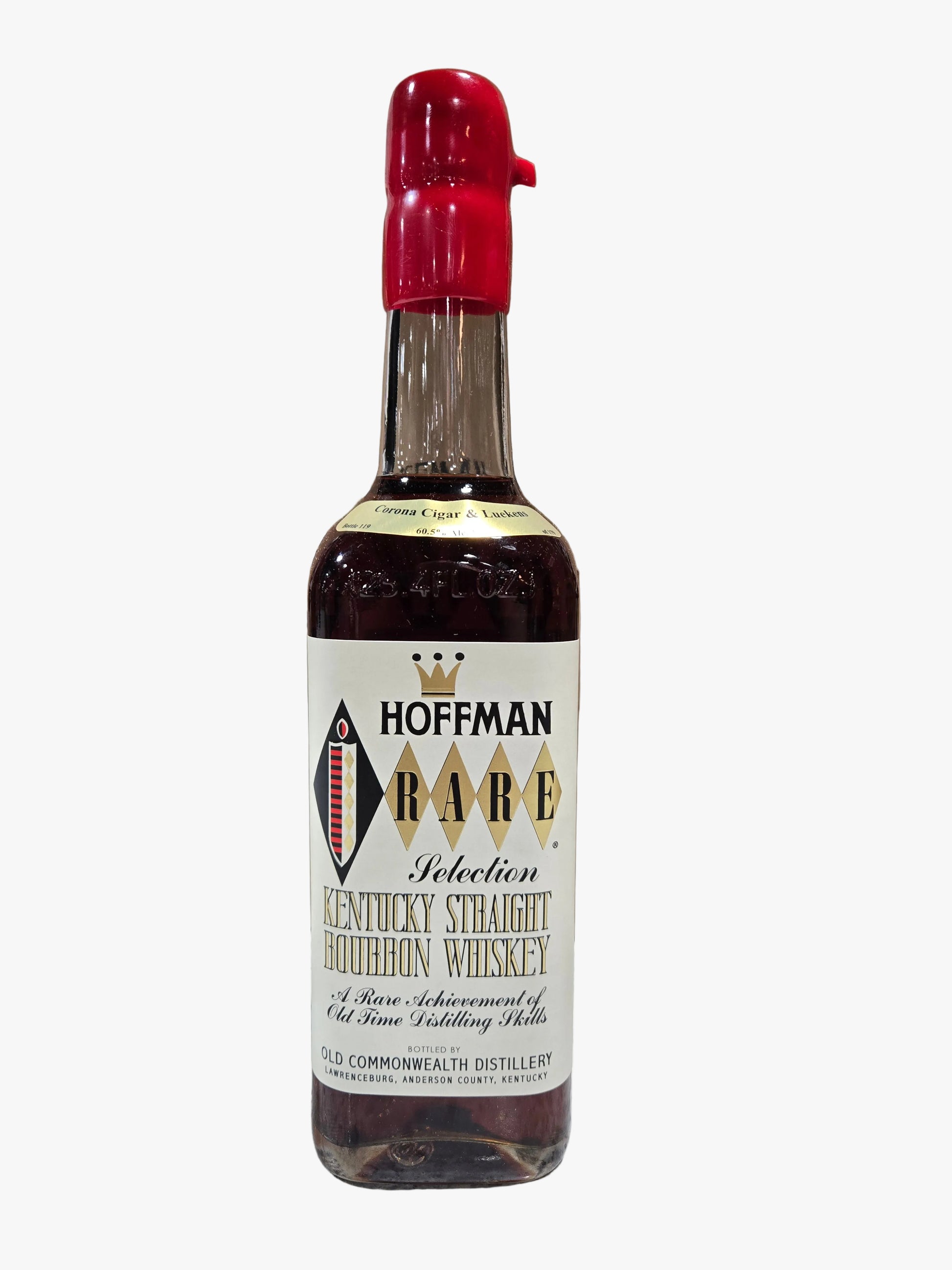 A bottle of Hoffman Rare Kentucky Straight Bourbon Whiskey stands in front of its open cardboard box on a marble countertop, with a blurred liquor store shelf background.