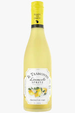 A bottle of Il Tramonto Limoncello Spritz non-alcoholic wine lemon oil, featuring a pale yellow liquid, a yellow screw cap, and a white label with lemon illustrations.