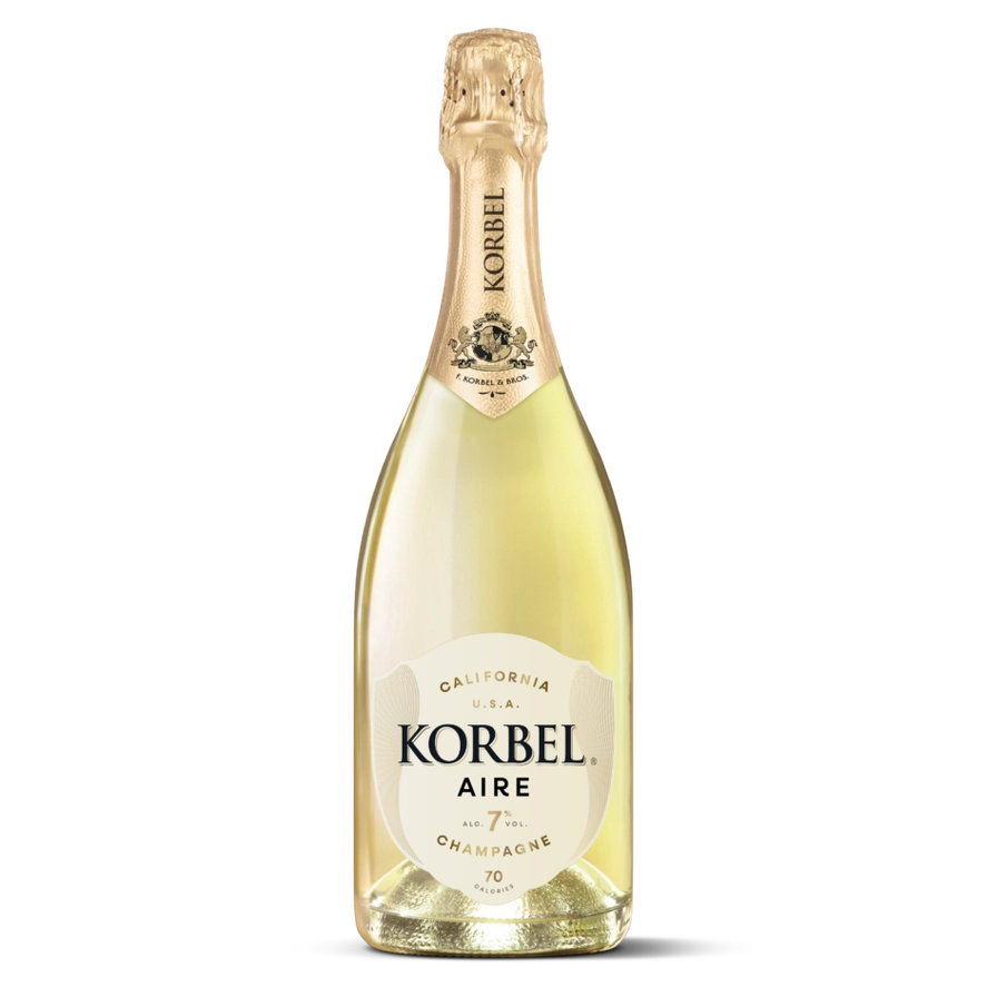 A bottle of Korbel Aire Champagne with pale golden liquid, a cream-colored label, and a gold foil neck wrap, isolated on a white background.