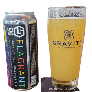 Can of 'Flagrant' hazy double India pale ale from Late Start Brewing next to a glass of beer at Gravity Taproom.