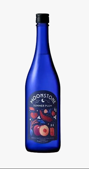 A cobalt blue glass bottle of Moonstone Summer Plum non-alcoholic gin and tonic, standing upright on a rustic wood slice against a textured light gray background.