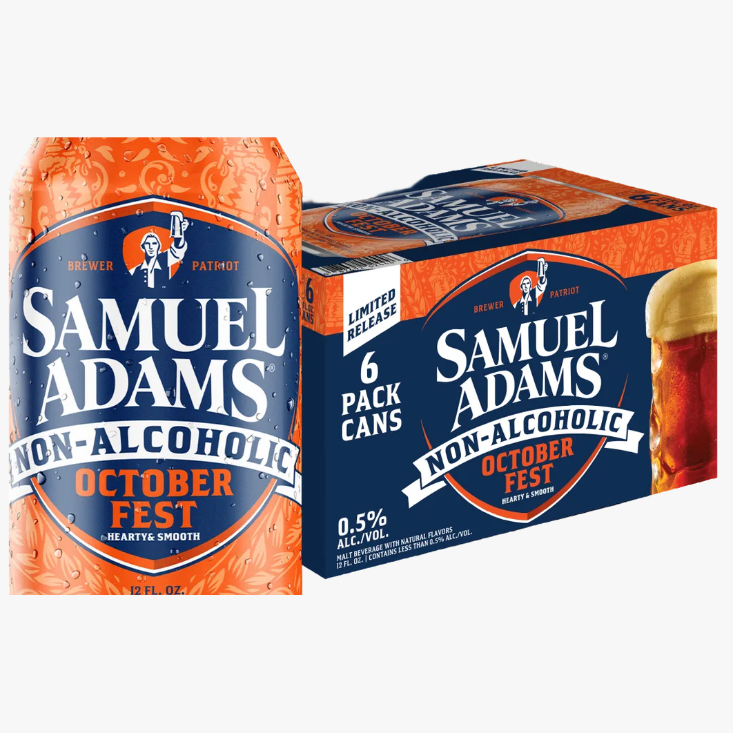 A bottle and a 6-pack box of Samuel Adams Non-Alcoholic October Fest beer on a plain white background. The packaging is predominantly dark blue and orange, with white text and a small illustration of a figure holding a flag.