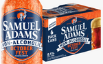 A bottle and a 6-pack box of Samuel Adams Non-Alcoholic October Fest beer on a plain white background. The packaging is predominantly dark blue and orange, with white text and a small illustration of a figure holding a flag.