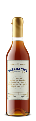 A bottle of Seelbach's Straight Bourbon Whiskey with a gold cap and a cream-colored label, shown against a plain white background.