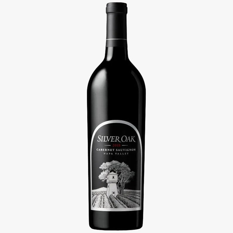 A bottle of Silver Oak Cabernet Sauvignon from Napa Valley, featuring a black bottle and a white label with a detailed illustration of a vineyard and winery.